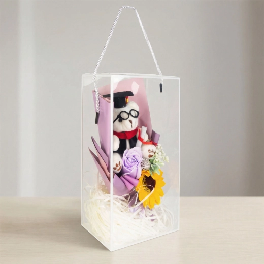 Artificial decoration with a sunflower and teddy bear in a gift box