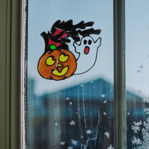 Halloween window decoration with pumpkin and ghost