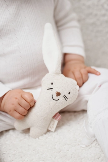 Sewn-in rattle for sound stimulation
