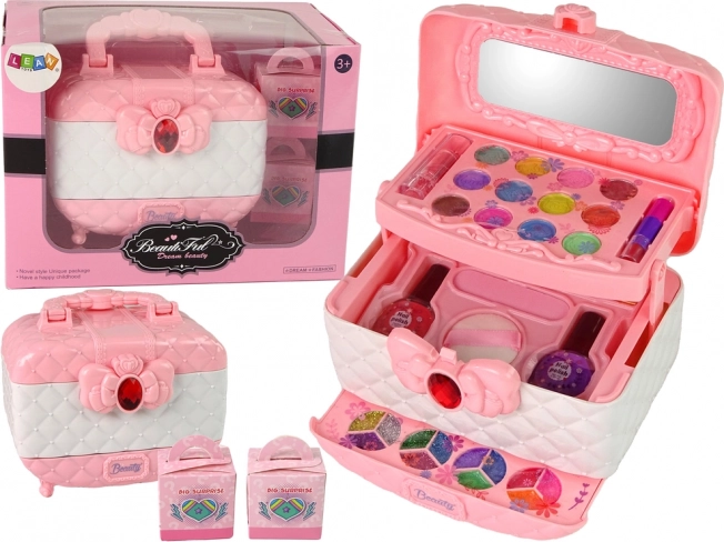 Children's pink-and-white cosmetic case with makeup and surprises